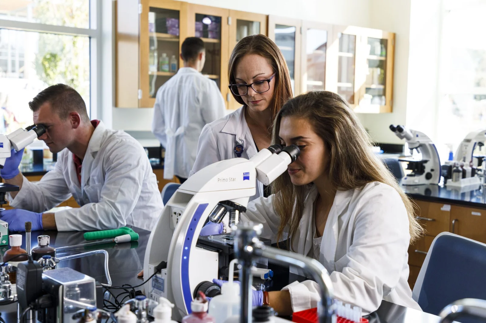 Biomedical professional analyzing data in a laboratory setting.