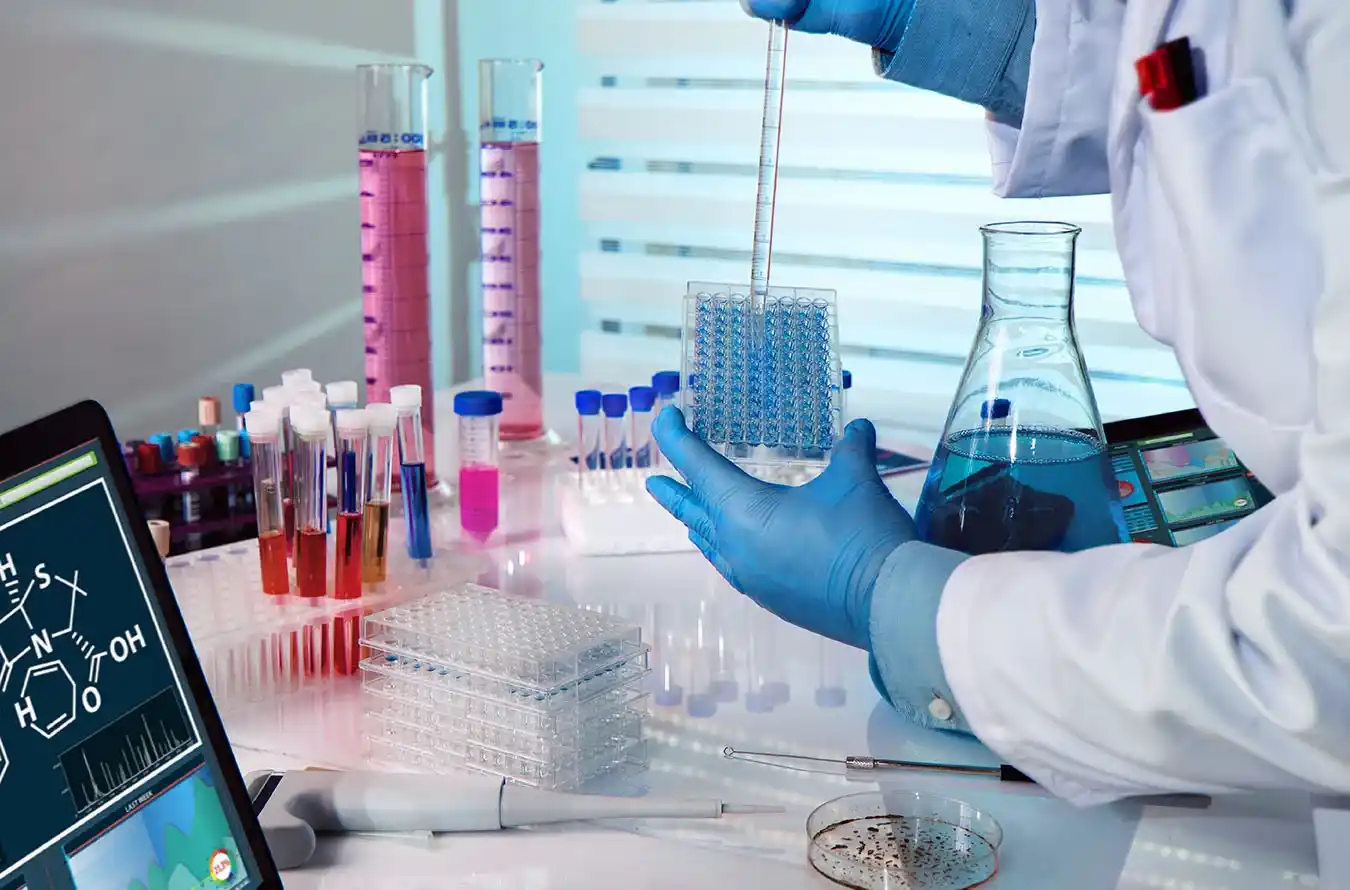 Chemical engineer wearing safety gear, working with laboratory equipment and chemical substances