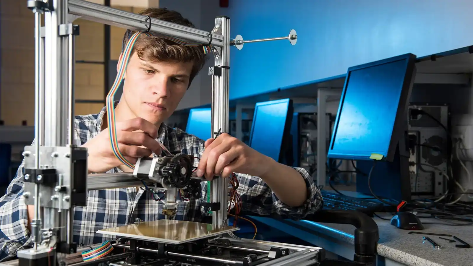 Mechatronics engineer working on a robotic system in a modern lab.