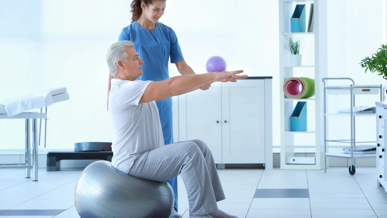 Physiotherapist guiding a patient through a rehabilitation exercise.